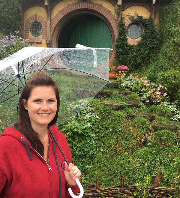 Kim with an umbrella near a hobbit's home.
